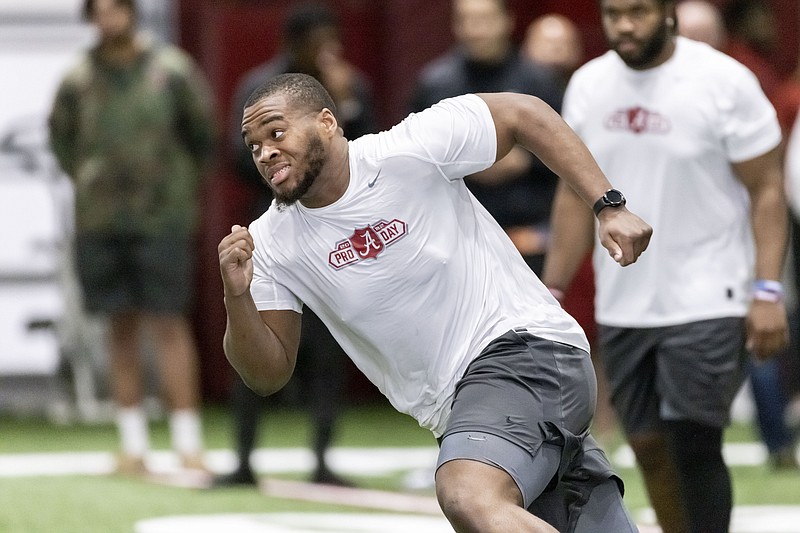 AP photo by Vasha Hunt / Former Alabama offensive lineman Evan Neal participates in position drills at the Crimson Tide's pro day Wednesday in Tuscaloosa.