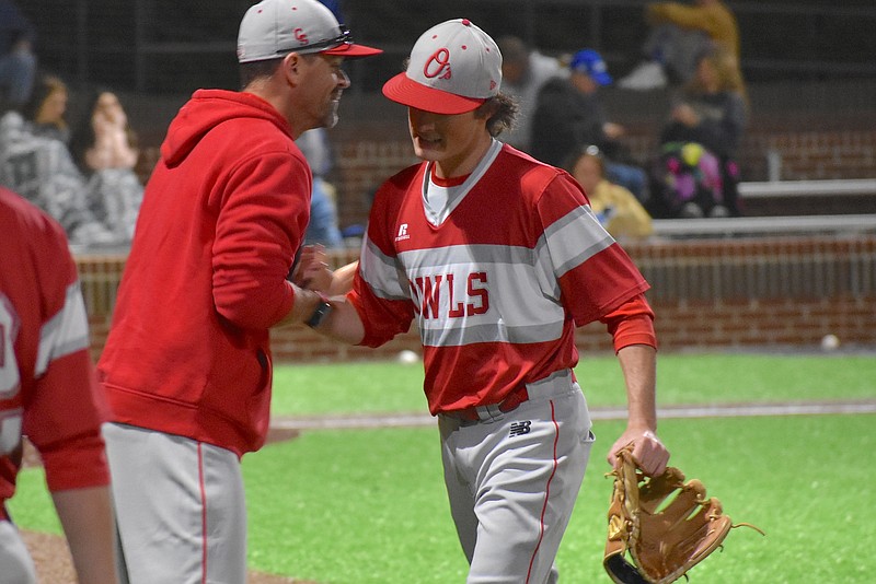 Staff photo by Patrick MacCoon / Ooltewah senior pitcher Zach Cates is congratulated by coach Brian Hitchcox after tossing a 112-pitch complete game in Thursday's 4-1 victory at Boyd Buchanan.