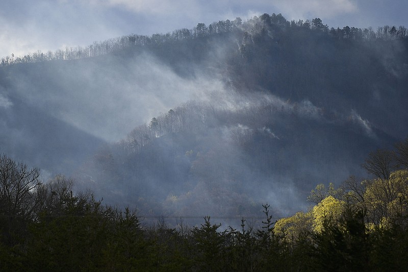 Associated Press photo / Smoke rises from mountains south of Seymour, Tenn., from the Hatcher Mountain Road/Indigo Lane Fire, as seen from Ellejoy Baptist Church in Seymour on Thursday.