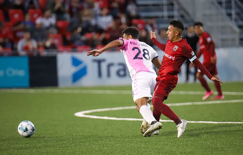 Staff photo by Olivia Ross / Chattanooga Red Wolves midfielder Jose Carrera-Garcia, right, battles with Forward Madison FC's Andrew Wheeler-Ominunu for possession during Saturday's match in East Ridge.