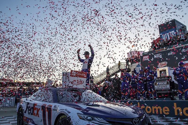 AP photo by Mike Caudill / Joe Gibbs Racing driver Denny Hamlin raises his hands in victory lane after winning Sunday's NASCAR Cup Series race at Virginia's Richmond Raceway.