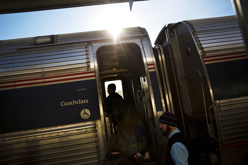 This file photo shows passengers boarding an Amtrak train heading to New Orleans from Atlanta on Wednesday, Nov. 23, 2016. A federal board is hearing testimony on whether to let Amtrak resume passenger train service linking New Orleans and Mobile, Alabama, over the objections of freight companies. A hearing began Monday, April 4, 2022 before the Surface Transportation Board. (AP Photo/David Goldman)