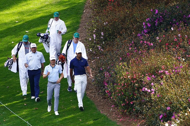 Fred Couples, left, Justin Thomas and Tiger Woods walk down the sixth fairway during a practice round for the Masters golf tournament on Monday, April 4, 2022, in Augusta, Ga. (AP Photo/Matt Slocum)