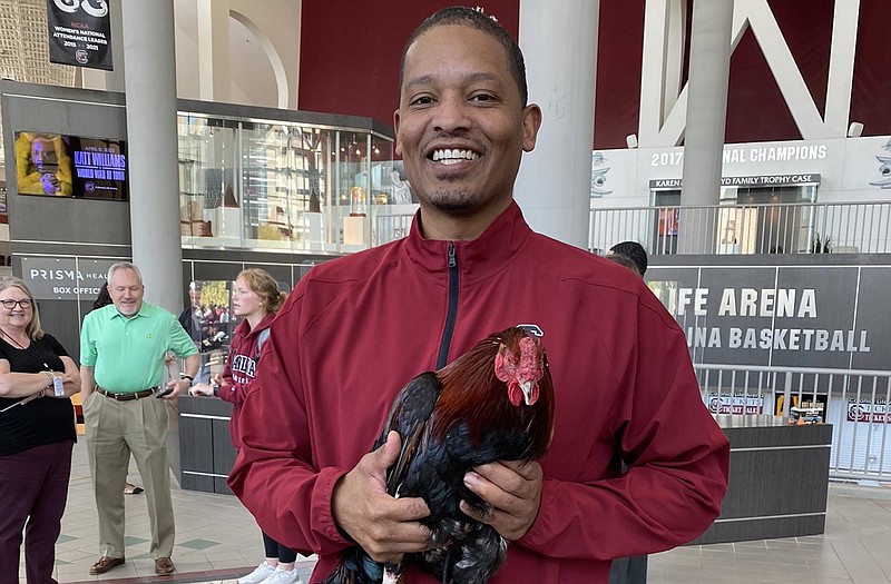 Photo contributed by Lamont Paris / Former UTC men's basketball coach Lamont Paris posed with a gamecock earlier this week inside South Carolina's Colonial Life Arena.