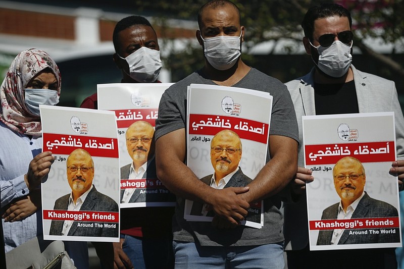 FILE - People hold posters of slain Saudi journalist Jamal Khashoggi, near the Saudi Arabia consulate in Istanbul, marking the two-year anniversary of his death, Oct. 2, 2020. A Turkish court ruled Thursday, April 7, 2022 to suspend the trial in absentia of 26 Saudis accused in the gruesome killing of Washington Post columnist Jamal Khashoggi and for the case to be transferred to Saudi Arabia. (AP Photo/Emrah Gurel, File)