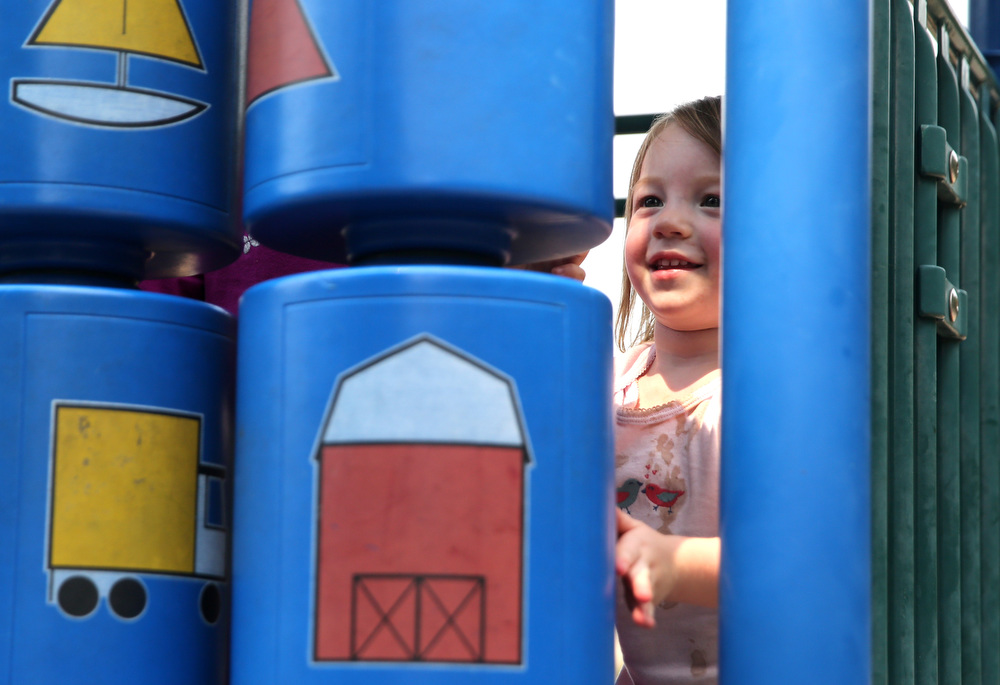Eloise Pickett, 2, spins playground equipment naming off colors and objects at Riverview Park Tuesday, Sept. 5, 2017, in Chattanooga, Tenn. Eloise quickly made friends with older children playing on the slides and joined in on the fun.