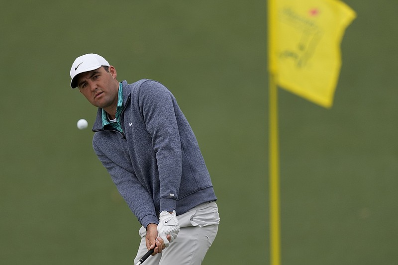 AP photo by Matt Slocum / Scottie Scheffler chips to the second hole at Augusta National on Saturday during the third round of the Masters. Scheffler shot a 71 and had a three-shot lead over Cameron Smith, who had the day's low round with a 68.