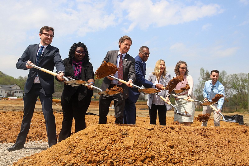 Staff photo by Olivia Ross / Local officials and developers participate in the groundbreaking of the Reserve at Mountain Pass on April 12, 2022. This affordable housing complex will be located in the Alton Park area.
