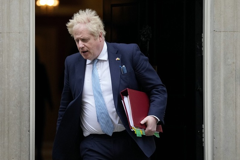 FILE - Britain's Prime Minister Boris Johnson leaves 10 Downing Street to attend the weekly Prime Ministers' Questions session in parliament in London, on March 30, 2022. U.K. Prime Minister Boris Johnson's office says he will be issued a fine for breaching COVID-19 regulations following allegations of lockdown parties at government offices. Treasury Chief Rishi Sunak will also be fined. (AP Photo/Frank Augstein)