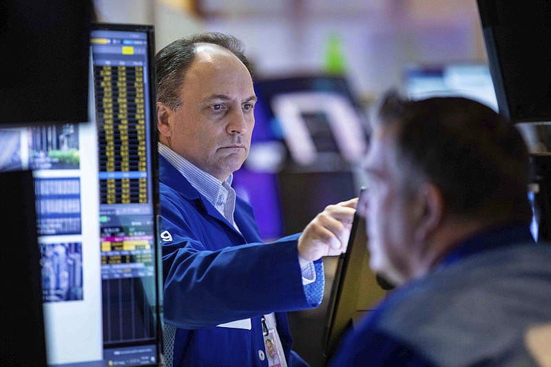 In this photo provided by the New York Stock Exchange, trader James Conti works on the floor, Thursday, April 14, 2022. Stocks wavered in morning trading on Wall Street Thursday as investors reviewed the latest economic data and corporate earnings amid lingering concerns about inflation and rising interest rates. (Courtney Crow/New York Stock Exchange via AP)