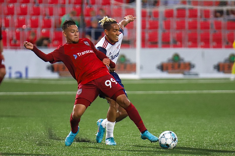 Staff photo by Olivia Ross  / The Chattanooga Red Wolves' Moe Espinoza keeps the ball away from the Richmond Kickers during a USL League One match Saturday night at CHI Memorial Stadium in East Ridge.