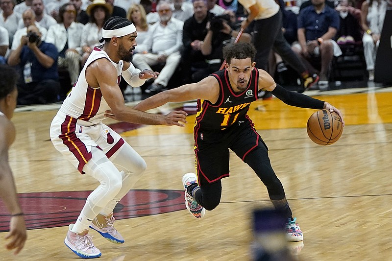 AP photo by Lynne Sladky / Atlanta Hawks point guard Trae Young dribbles while guarded by the Miami Heat's Gabe Vincent during their Eastern Conference playoff series opener Sunday in Miami. Young shot 1-for-12 and scored eight points as the Hawks lost 115-91.