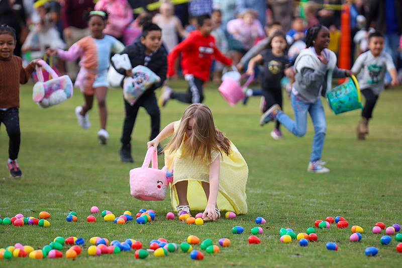 Staff photo by Olivia Ross  / Children excitedly pick up as many eggs as they can during Easter at Coolidge on April 17, 2022. The event, presented by Stuart Heights Baptist Church, featured an egg hunt, live music, and Easter worship service. 