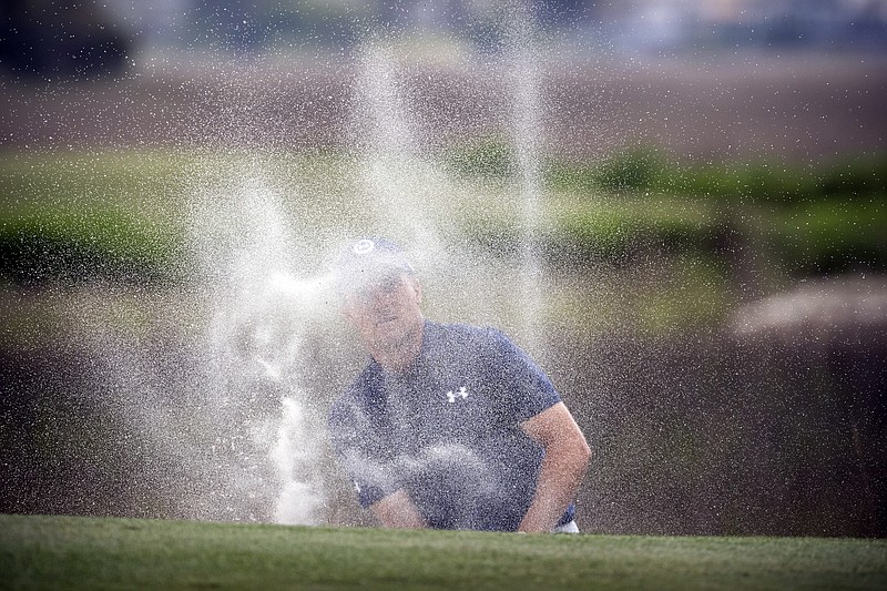 AP photo by Stephen B. Morton / Jordan Spieth watches his shot out of the bunker on the 18th hole from behind a cloud of sand during a one-hole playoff with Patrick Cantlay at the RBC Heritage on Sunday.
