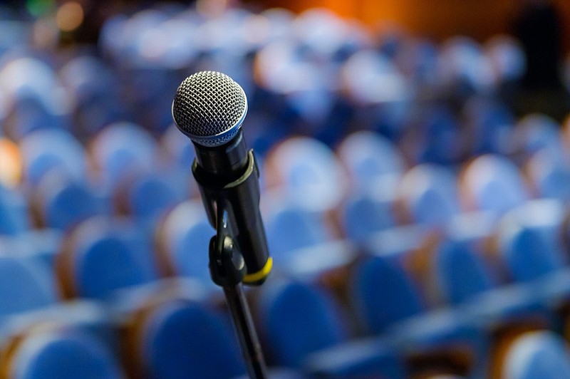 Microphone close up at the conference - stock photo debate tile / Getty Images

