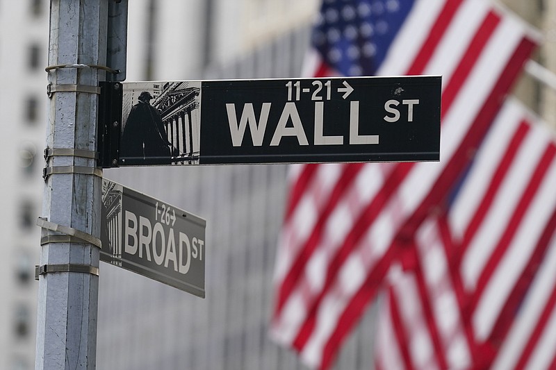 FILE - A street sign is seen in front of the New York Stock Exchange in New York, Tuesday, June 14, 2022. Stocks are rising solidly higher in early trading on Wall Street Tuesday, June 28. Travel-related companies were among the biggest winners after China eased a quarantine requirement for people arriving from abroad, raising hopes that the severe pandemic lockdowns there might be starting to ease.(AP Photo/Seth Wenig, File)