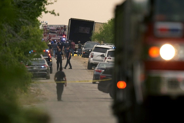 Body bags lie at the scene where a tractor trailer with multiple dead bodies was discovered, Monday, June 27, 2022, in San Antonio. (AP Photo/Eric Gay)