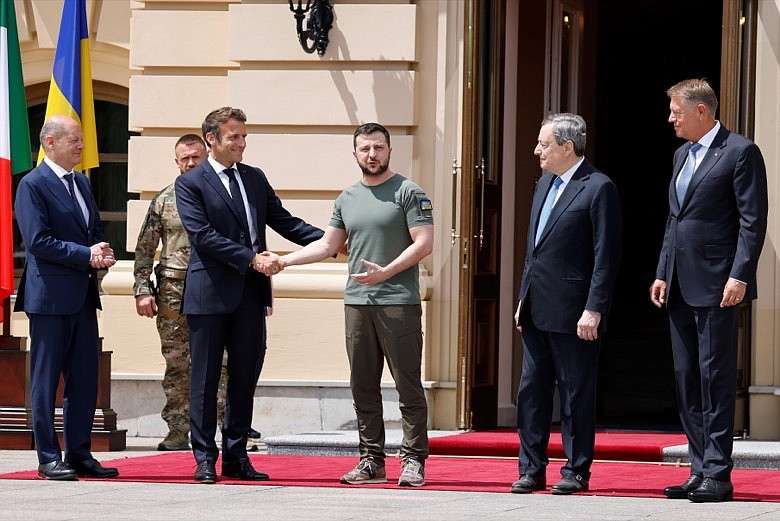 German Chancellor Olaf Scholz, left, watches Ukrainian President Volodymyr Zelenskyy shakes hands with French President Emmanuel Macron, second left, as Romanian President Klaus Iohannis, right, and Italian Prime Minister Mario Draghi look on before a meeting in Kyiv, Thursday, June 16, 2022. Seven decades after it was founded, the North Atlantic Treaty Organization is meeting in Madrid on June 29 and 30, 2022 with an urgent need to reassert its original mission: preventing Russian aggression against Western allies. (Ludovic Marin, Pool via AP, File)