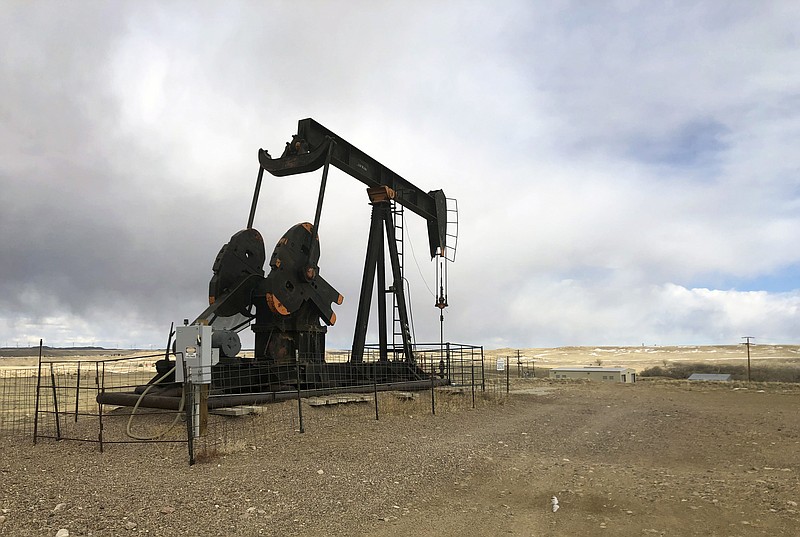 This Feb. 26, 2021, file photo shows an oil well east of Casper, Wyo. The Biden administration is raising royalty rates that companies must pay for oil and natural gas extracted from federal lands as it moves forward under court order with sales of public fossil fuel reserves in nine states. (AP Photo/Mead Gruver, File)
