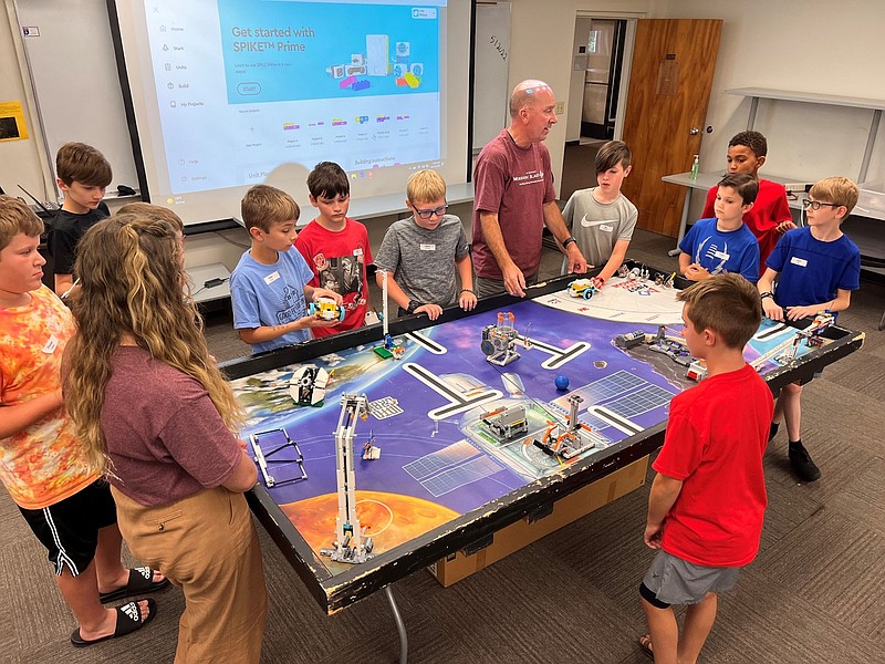 Contributed photo / Intermediate campers work with Scott Rosenow from Tennessee Valley Robotics to select missions for their robotics design and programming.