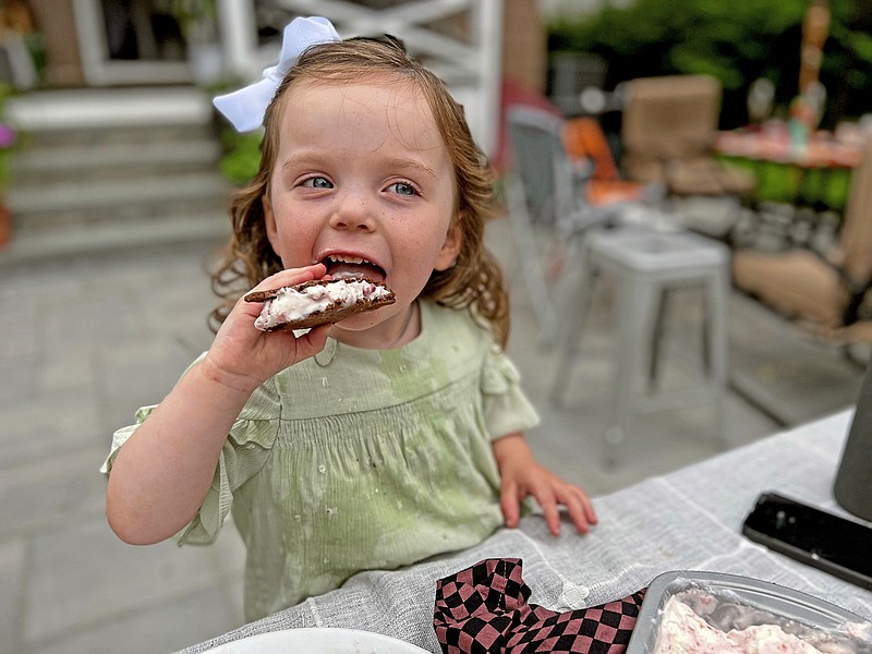 Greta McKay, 2, enjoys a homemade ice cream sandwich filled with no-churn strawberry ice cream. / Gretchen McKay/Pittsburgh Post-Gazette/TNS