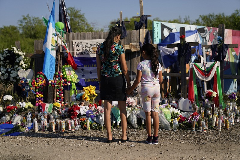 Photo by Eric Gay of The Associated Press / Mourners visit a make-shift memorial at the site where dozens of suspected migrants died in an abandoned tractor-trailer on Thursday, June 30, 2022, in San Antonio.