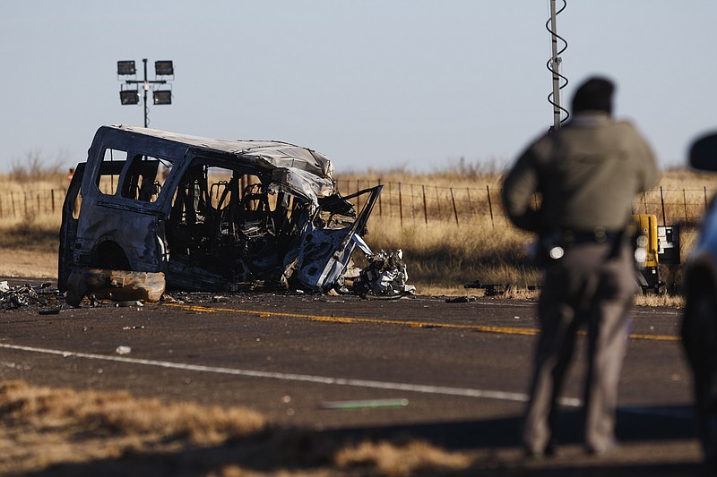 Eli Hartman/Odessa American via AP / Texas Department of Public Safety Troopers look over the scene of a fatal car wreck in Andrews County, Texas, in March of this year.