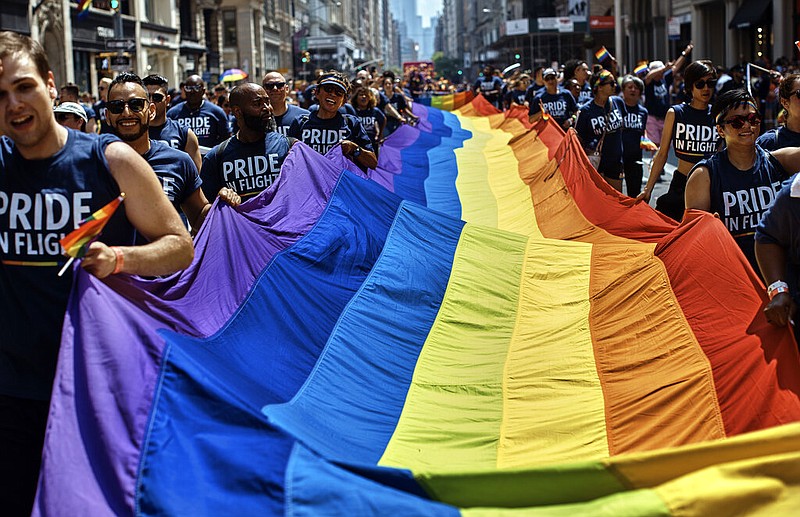 Reveler carry a LTBGQ flag along Fifth Avenue during the New York City Pride Parade on Sunday, June 24, 2018, in New York. Parades celebrating LGBTQ pride kick off in some of America's biggest cities Sunday amid new fears about the potential erosion of freedoms won through decades of activism. The annual marches in New York, San Francisco, Chicago and elsewhere take place just two days after one conservative justice on the Supreme Court signaled, in a ruling on abortion, that the court should reconsider the right to same-sex marriage recognized in 2015. (AP Photo/Andres Kudacki, File)