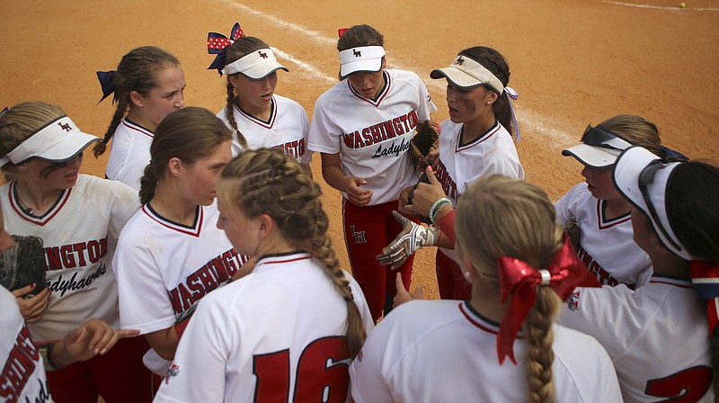 Staff photo / The Washington Ladyhawks huddle during their game against the Tulsa Elite in the Amateur Softball Association's 14U girls national tournament in August 2017 at the Summit of Softball complex in Ooltewah.