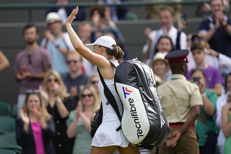 AP photo by Kirsty Wigglesworth/ Iga Swiatek leaves the court after losing to Alize Cornet on Saturday in a third-round match at Wimbledon.