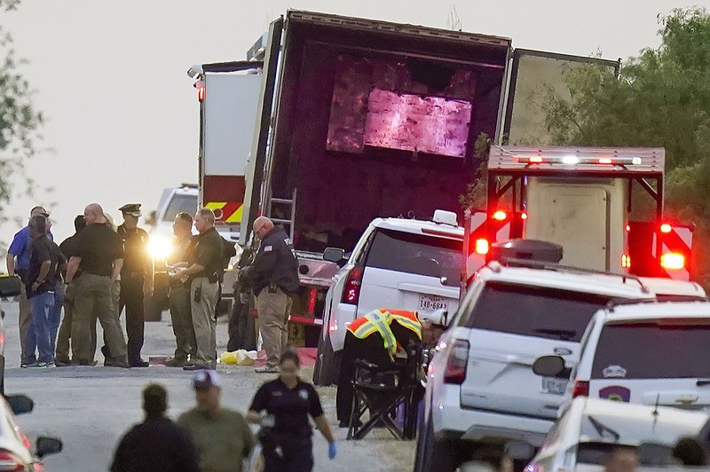 Police and other first responders work the scene where officials say dozens of people have been found dead and multiple others were taken to hospitals with heat-related illnesses after a semitrailer containing suspected migrants was found, Monday, June 27, 2022, in San Antonio. F (AP Photo/Eric Gay, File)