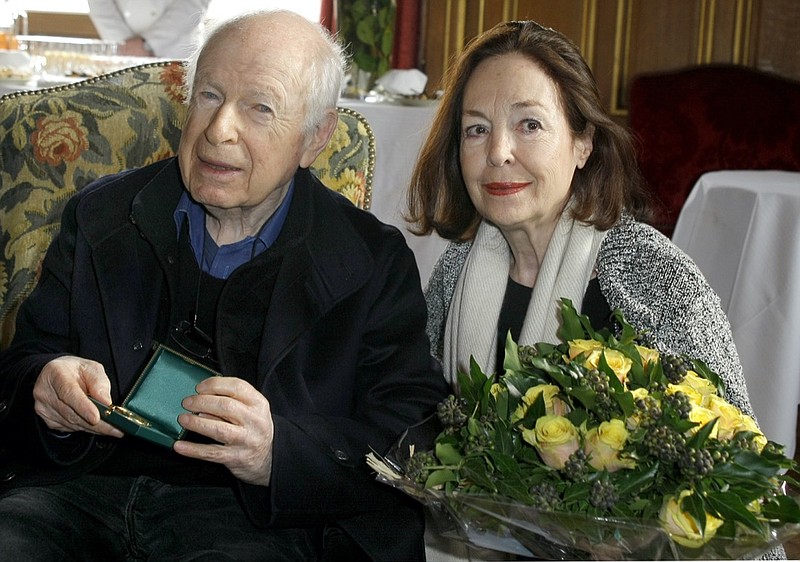 FILE - British theatre director Peter Brook poses with his wife Natasha after being awarded the Great Vermeil medal of Paris, during a reception at the city hall Tuesday, Jan. 25, 2011. Brook, a British theater director known for an influential and distinguished career which saw him garner worldwide acclaim, has died. He was 97.  The two-time Tony Award winner, who had settled in France since the 1970s, also directed the film adaptations of his best stage works as well as the 1963 release of “Lord of the Flies”. (AP Photo/Jacques Brinon, File)