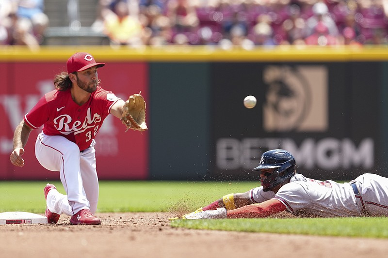 AP photo by Jeff Dean / The Atlanta Braves' Ronald Acuna Jr. steals second base as Cincinnati Reds second baseman Max Schrock awaits the throw during the third inning of Sunday's game.