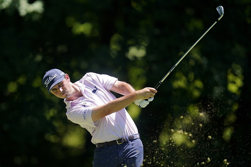 AP photo by Charlie Neibergall / J.T. Poston hits off the sixth tee at TPC Deere Run during the final round of the PGA Tour's John Deere Classic on Sunday in Silvis, Ill.