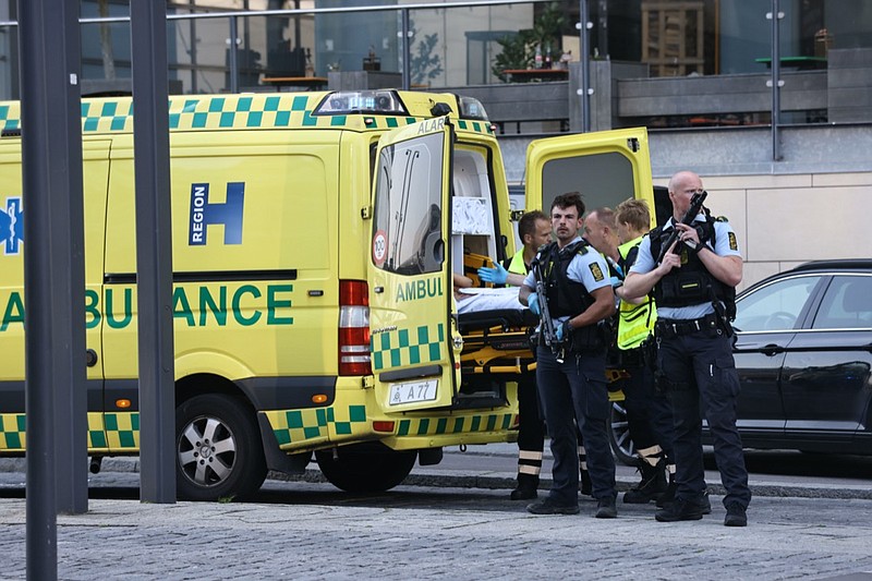 An ambulance and armed police outside the Field's shopping center, in Orestad, Copenhagen, Denmark, Sunday, July 3, 2022, after reports of shots fired. (Olafur Steinar Gestsson /Ritzau Scanpix via AP)

