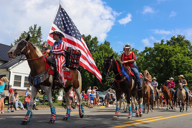 Staff photo by Olivia Ross  / Horses and their riders wear patriotic accessories as they make their way through the parade. Dunlap, TN celebrates Independence Day with a parade on July 4, 2022. 