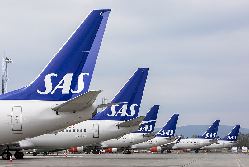 FILE - SAS planes are grounded at Oslo Gardermoen airport during pilots strikes, in Oslo, Friday, April 26, 2019. SAS has filed for bankruptcy in the United States, warning the announcement of a strike by 1,000 pilots a day earlier had put the future of the carrier at risk which added to the travel chaos across Europe as the summer vacation period begins. The group said Tuesday, July 5, 2022 it had "voluntarily filed for chapter 11 in the U.S.," and said its operations and flight schedule will be unaffected. (Ole Berg-Rusten/NTB Scanpix via AP, File)