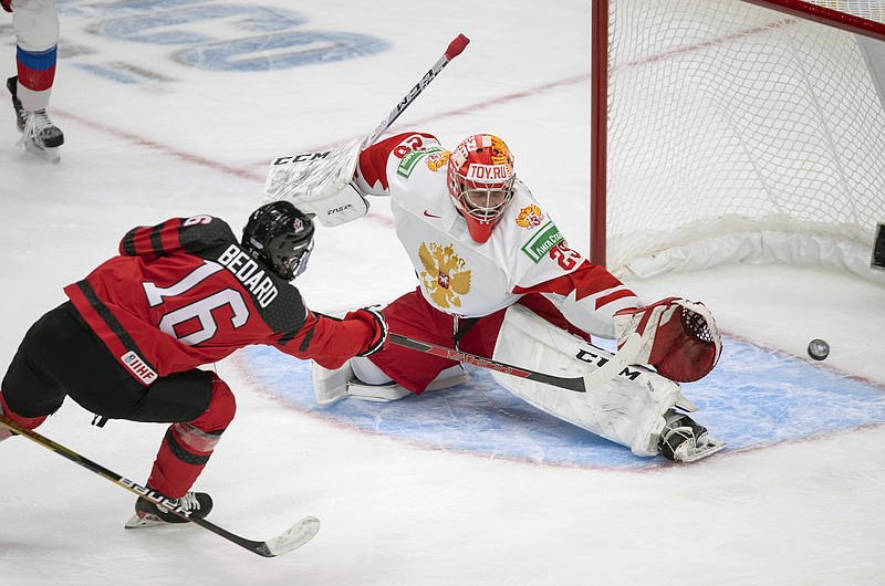 Canada's Connor Bedard (16) scores on Russia goalie Yegor Guskov during an 2021 exhibition game in Edmonton, Alberta. Yegor Guskov is one of several Russian goaltenders eligible to be taken in the 2022 NHL draft.