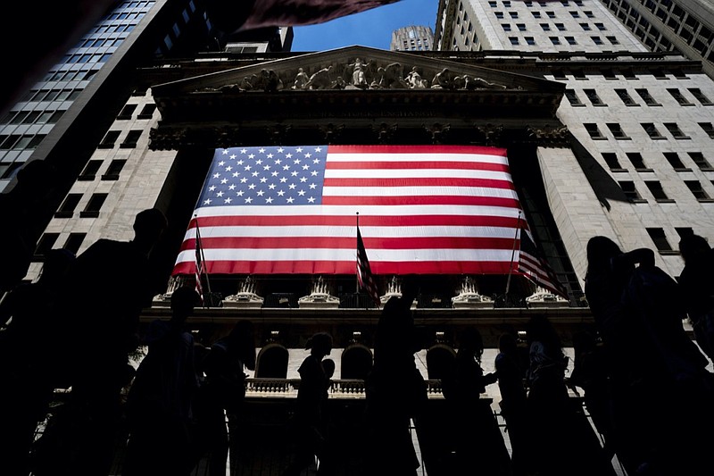 People walk past the New York Stock Exchange on Wednesday, June 29, 2022 in New York. Stocks are opening lower across the board on Wall Street, Tuesday, July 5, and crude oil prices are dropping again. Treasury yields also fell as traders continued to worry about the state of the economy (AP Photo/Julia Nikhinson)

