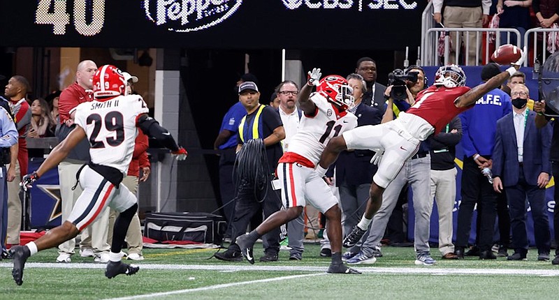 Crimson Tide photos / Alabama receiver Jameson Williams stretches out for a reception with Georgia's Derion Kendrick defending during the Crimson Tide's 41-24 victory in last December's Southeastern Conference championship contest. The win resulted in a 29th league title for Alabama, but the Bulldogs would avenge that defeat in the national title game.