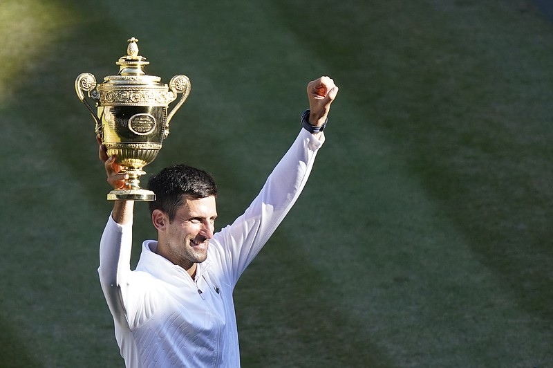 AP photo by Gerald Herbert / Novak Djokovic holds his trophy after beating Nick Kyrgios to win Sunday's Wimbledon final, 4-6, 6-3, 6-4, 7-6 (3). Djokovic won the grass court Grand Slam for the fourth time in a row and seventh time overall, running his overall count for major championships to 21.