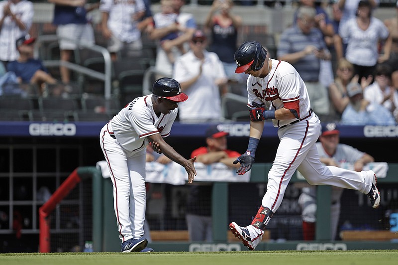 AP photo by Ben Margot / Atlanta Braves third baseman Austin Riley, right, celebrates with third base coach Ron Washington after hitting a home run in the eighth inning of Sunday's home game against the Washington Nationals.