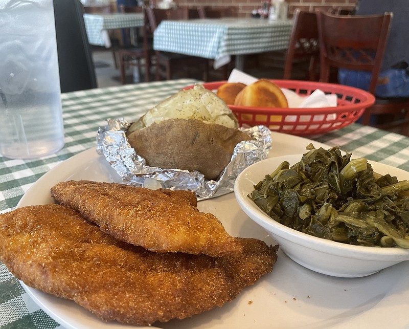 Photo by Anne Braly / A dinner of fried catfish, baked potato, turnip greens and corn muffins at the Dunlap Restaurant.