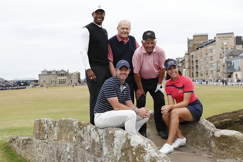 Tiger Woods of the US, Northern Ireland's Rory McIlroy, Jack Nicklaus, Lee Trevino of the United States and England's Georgia Hall pose for a photo on the Swilken bridge during a 'Champions round' as preparations continue for the British Open golf championship on the Old Course at St. Andrews, Scotland, Monday July 11, 2022. The Open Championship returns to the home of golf on July 14-17, 2022, to celebrate the 150th edition of the sport's oldest championship, which dates to 1860 and was first played at St. Andrews in 1873. (AP Photo/Peter Morrison)
