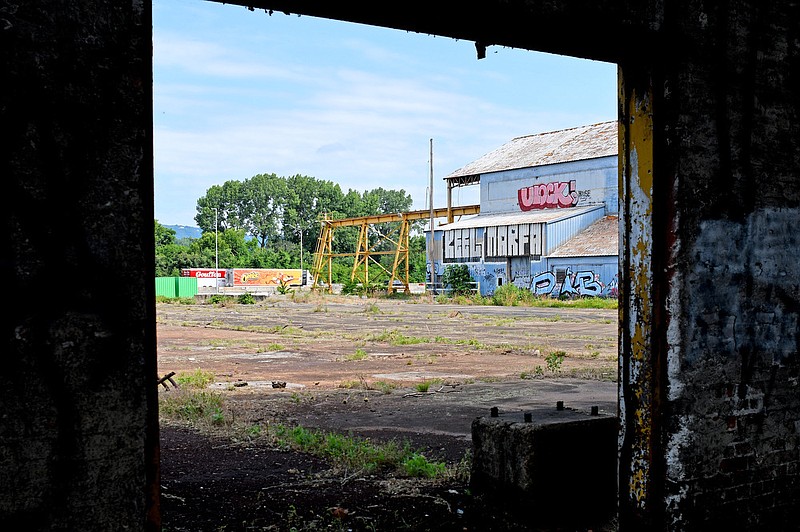 Staff Photo by Robin Rudd / Traffic passes on Interstate 24 in this view from a ruined doorway at the former Wheland Foundry as Hamilton County and city of Chattanooga officials on June 30 announced plans to develop the area with a new baseball stadium as the anchor.