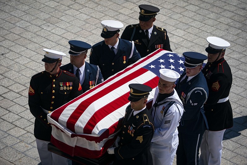 The flag-draped casket bearing the remains of Hershel W. "Woody" Williams is carried by joint service members into the U.S. Capitol, Thursday, July 14, 2022 in Washington, to lie in honor. Williams, the last remaining Medal of Honor recipient from World War II, died at age 98. (Al Drago/Pool Photo via AP)

