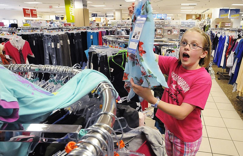 Mickey Welsh/Montgomery Advertiser via AP / Victoria Blocker shows a skirt to her mother as she shops with her family during the sales tax holiday at Eastdale Mall in Montgomery, Ala., in 2011. This year's sales tax holiday in Alabama continues through Sunday.