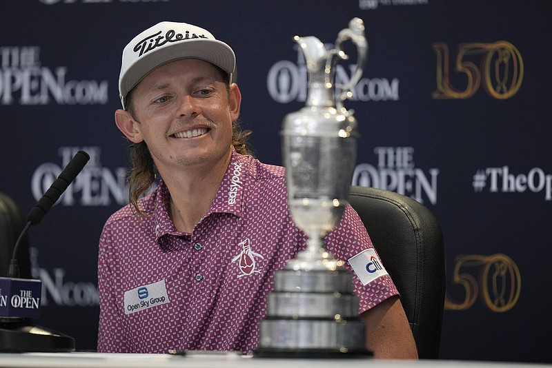 AP photo by Alastair Grant/ Cameron Smith looks at the claret jug trophy during the champion's news conference Sunday at the British Open. Smith closed with an 8-under-par 64 on the Old Course at St. Andrews, Scotland, for a one-stroke win at 20 under.