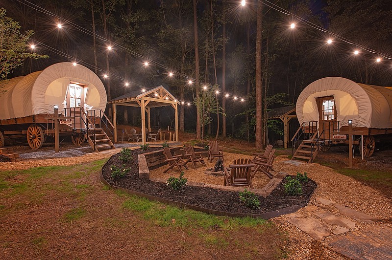 Photo by Timberroot Rustic Retreats / Welcome Valley Village's Conestoga wagons surround a communal fire pit.