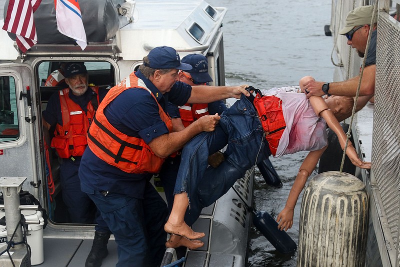 Staff photo by Olivia Ross  / Oscar, a water-rescue training dummy, is brought back by U.S. Coast Guard after rescue on July 19, 2022. The Coast Guard and other local, county and state agencies conducted a large-scale drill at Tennssee Riverpark to enhance maritime incident response and readiness. 